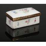 An 18th century enamel and porcelain rectangular snuff box. Painted with flowers and with raised