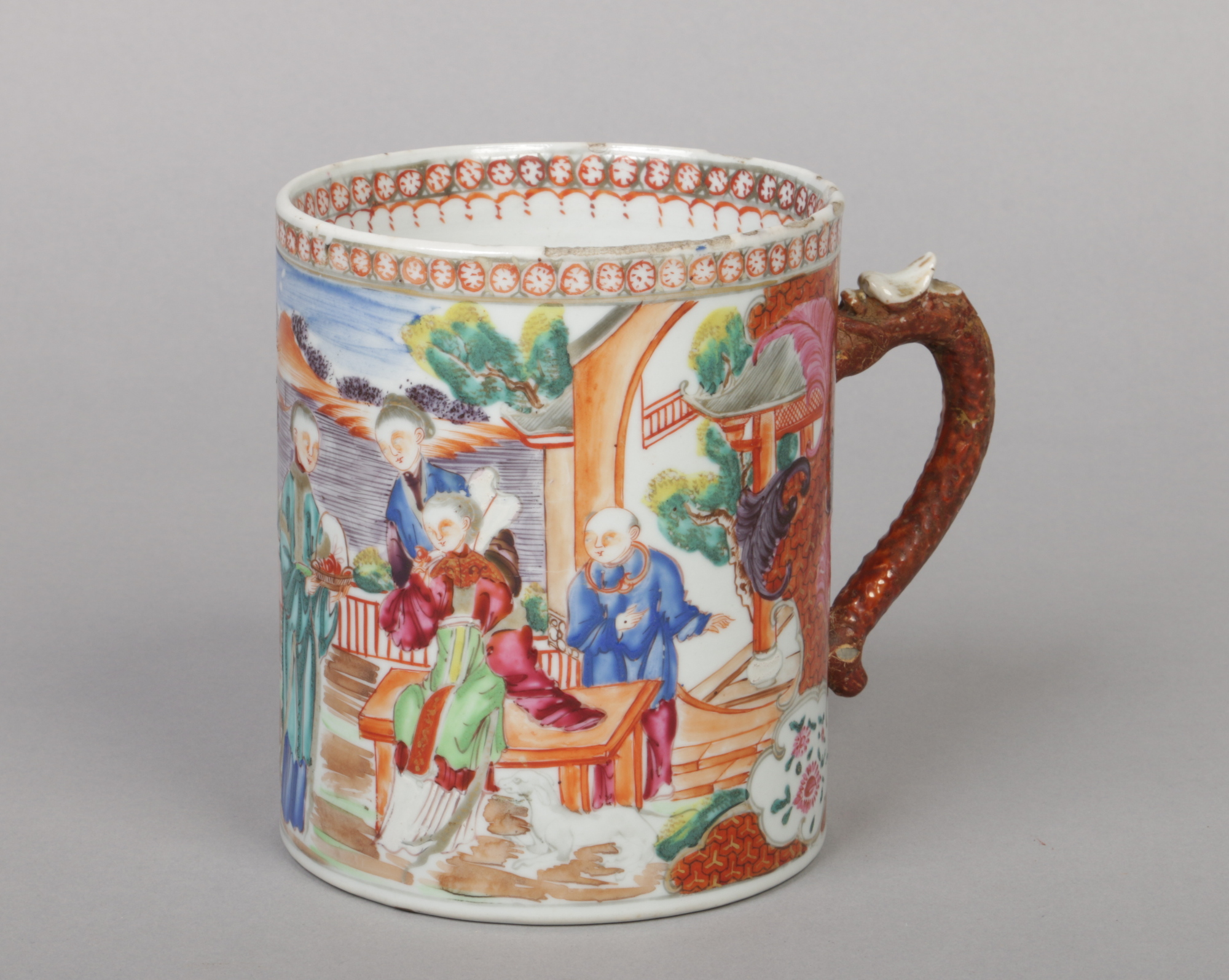 An 18th century Chinese export porcelain tankard with scrolling dragon handle. Decorated in coloured