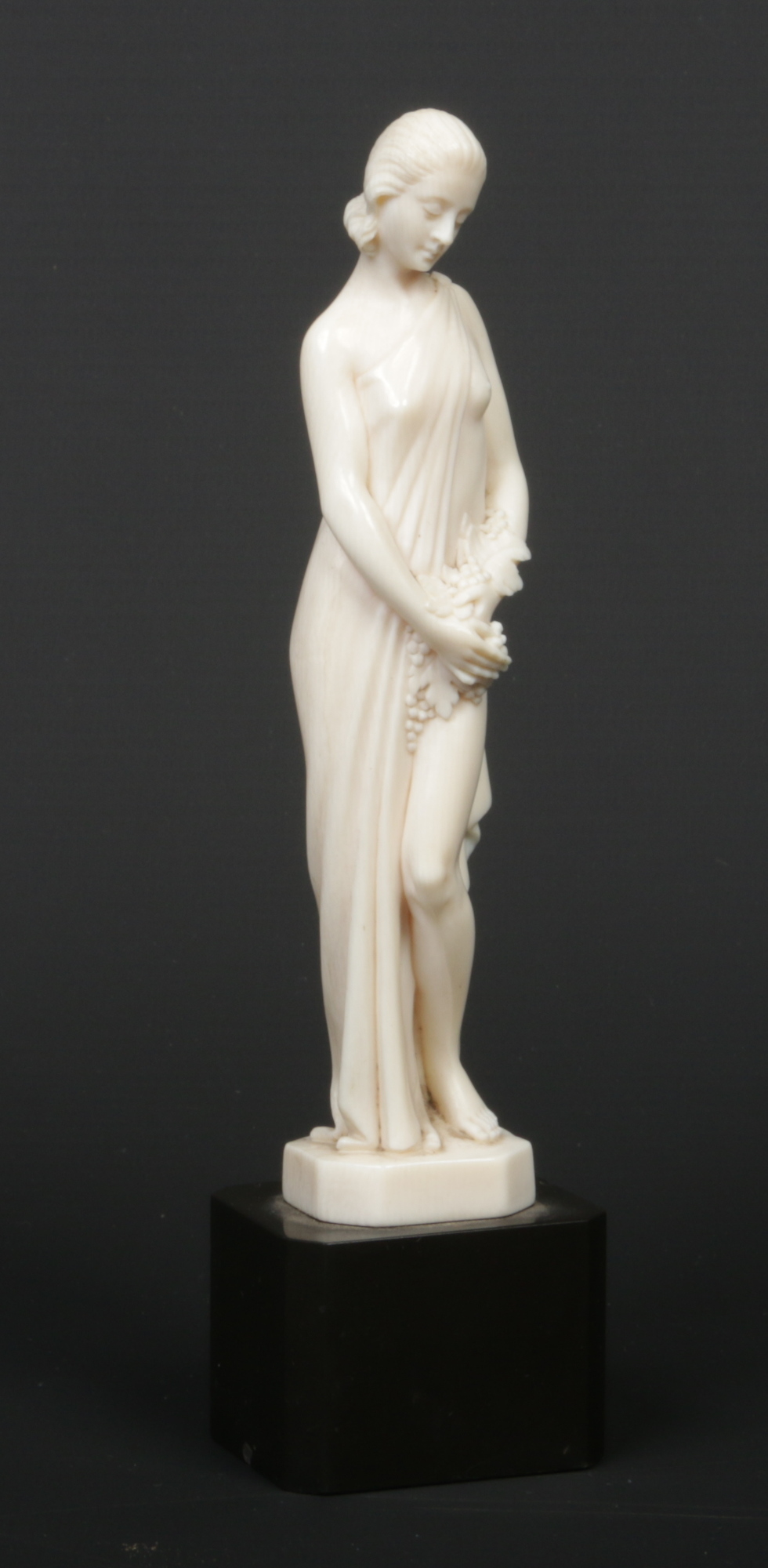 A. Boulard (French) an Art Deco carved ivory figure of a maiden draped in a robe and holding a