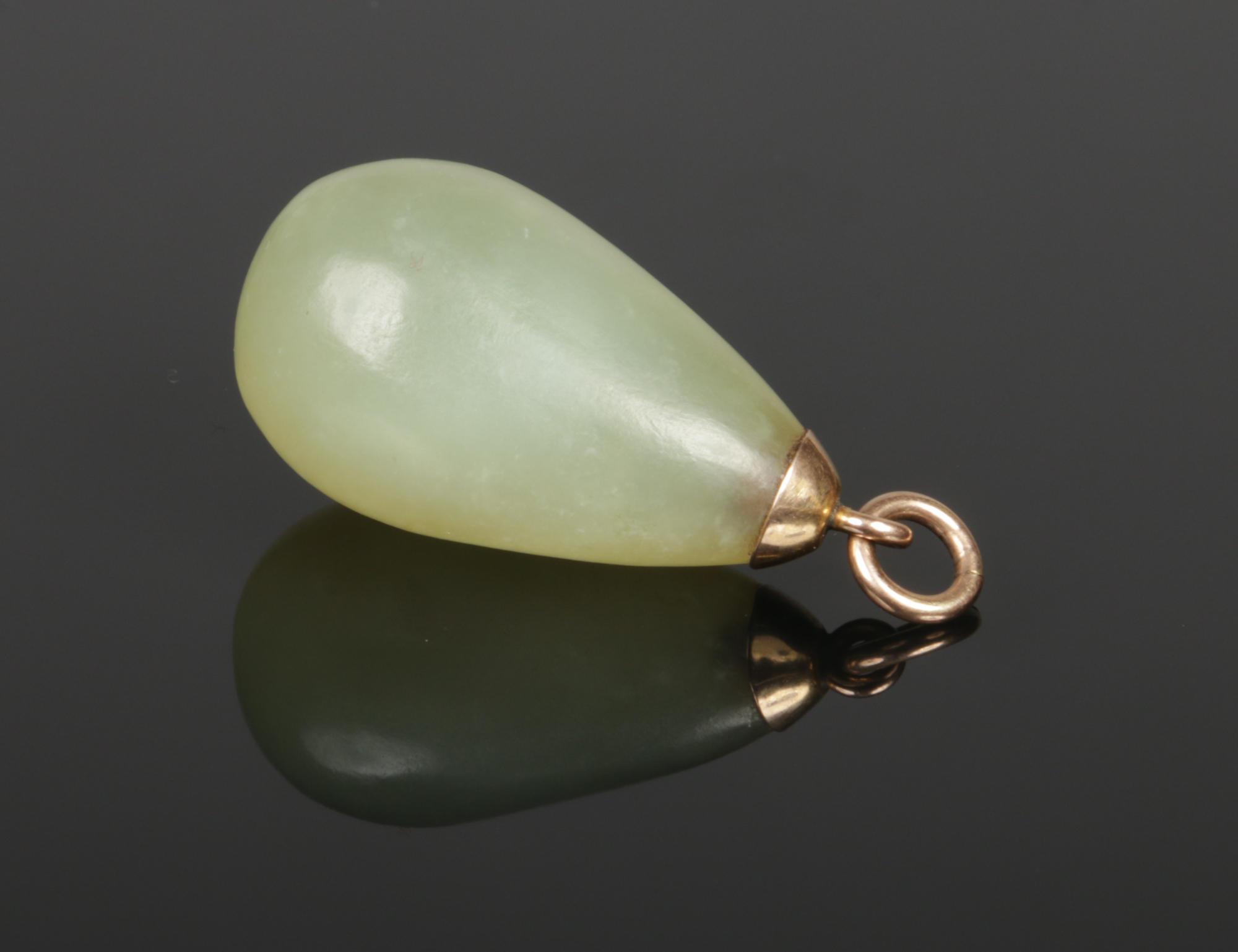 A carved celadon jade pear formed pendant with yellow metal mount, 35mm.Condition report intended as