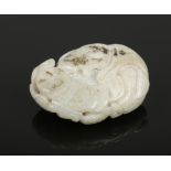 A Chinese jade carving. Depicting a figure with a phoenix, fruit bat, carp and a string of coins,