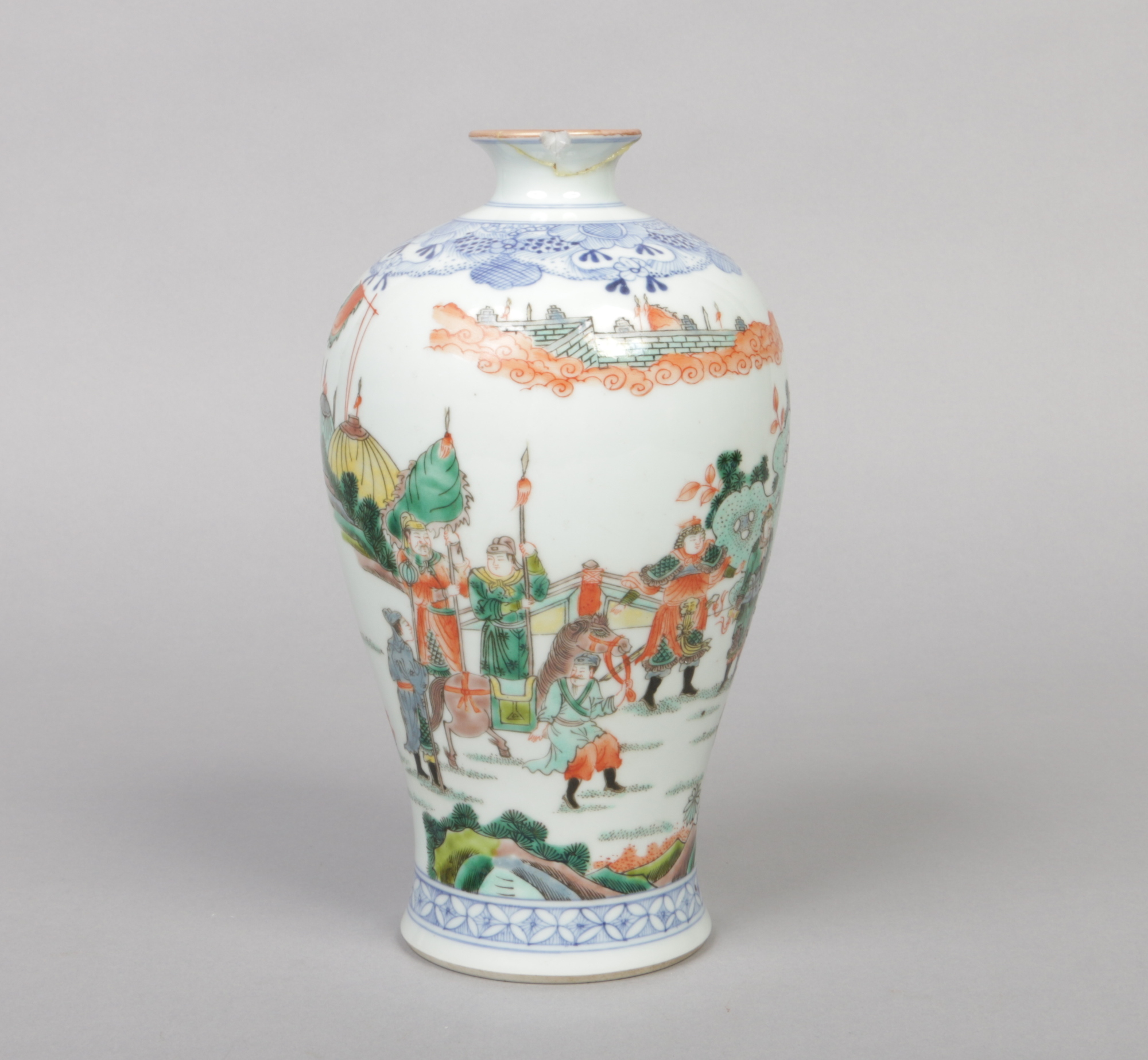 A Chinese famille verte meiping vase. Painted with an underglaze blue lambrequin collar and with a