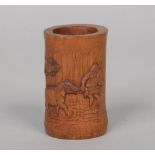 A small Chinese bamboo bitong. Carved with a figure leading a horse through water and with pine