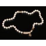 A ladies pearl necklace with 9 carat gold clasp and pendant set with diamonds.