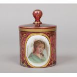 A 19th century Bohemian cranberry glass jar and cover. Decorated with gilt scrollwork and a