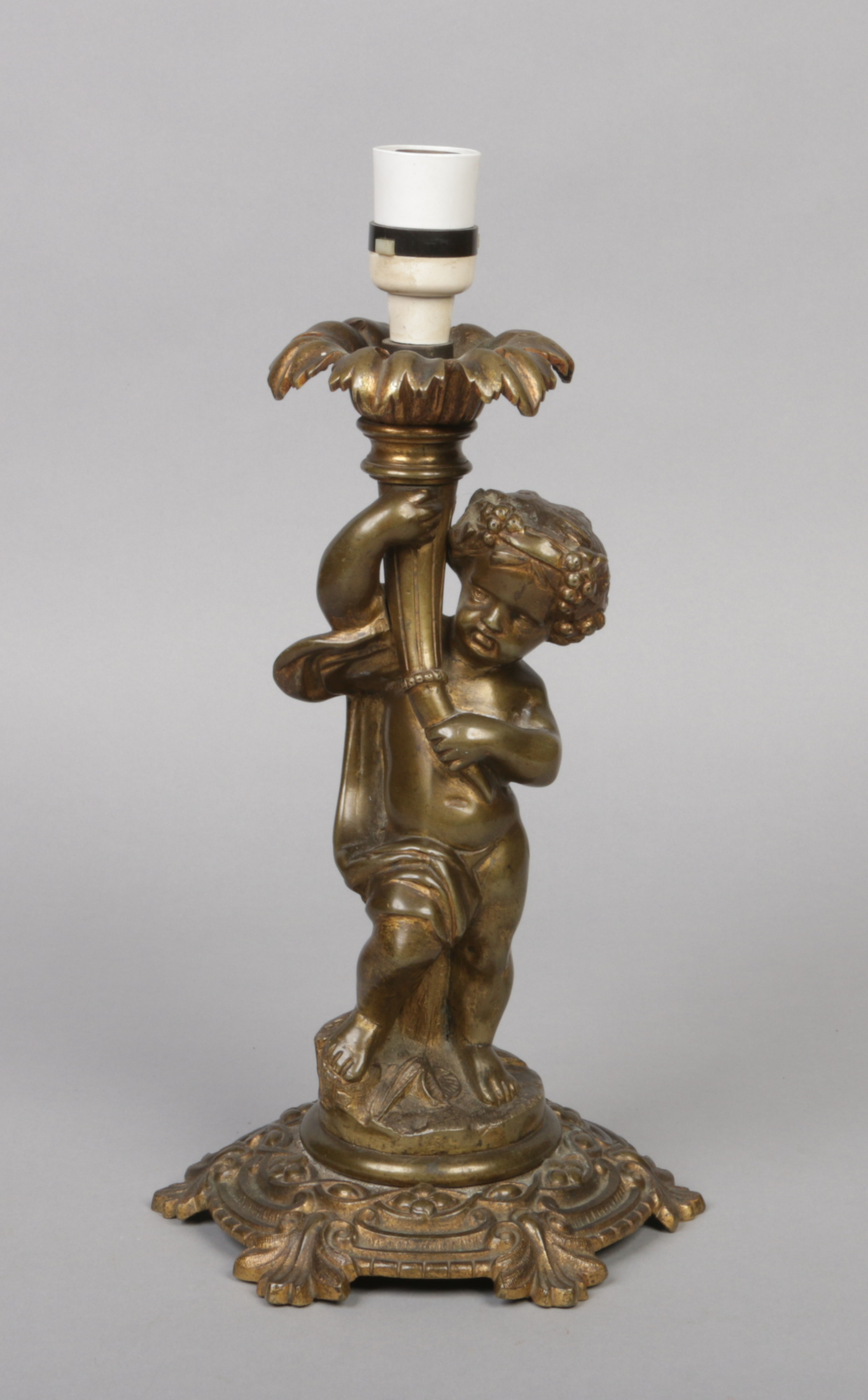 An early 20th century French gilt bronze tablelamp base. Formed as a putti holding a cornucopia