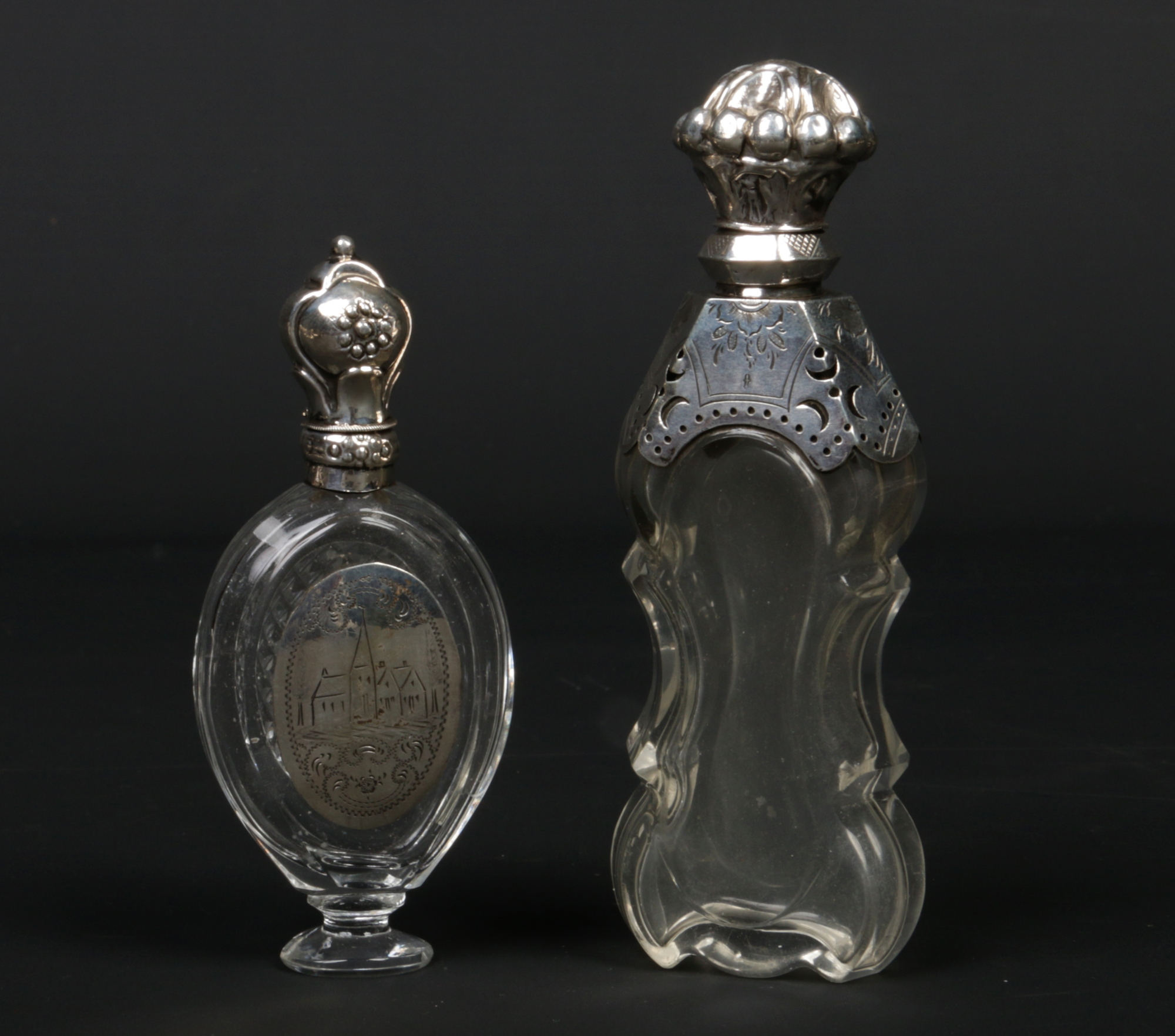 Two 19th century French silver mounted crystal scent bottles. One of pedestal form and with engraved