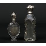 Two 19th century French silver mounted crystal scent bottles. One of pedestal form and with engraved