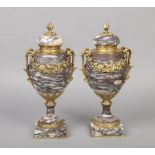 A pair of 19th century ormolu mounted marble lidded urns. With twin scrolling handles, flower