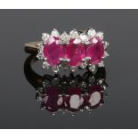 A 9ct gold ruby and diamond triple cluster ring set with three ovoid rubies and eighteen brilliant