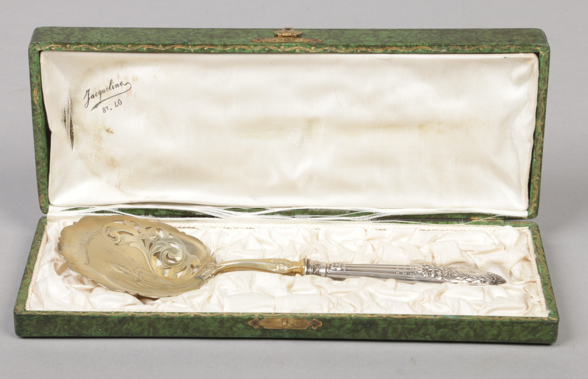 An early 20th century French cased silver and silver gilt serving spoon. Engraved to the pierced and