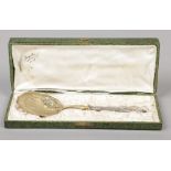 An early 20th century French cased silver and silver gilt serving spoon. Engraved to the pierced and