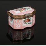 An 18th century enamel pill box of serpentine form. Pink ground, with raised white enamel and