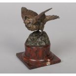 A late 19th century bronze sculpture of a partridge. Raised on an antico rosso marble pedestal, 16.