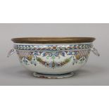 An 19th century Rouen Faience bowl with metal rim and twin shell moulded handles. Painted in