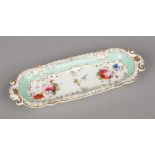 A Rockingham pen tray with C-scroll moulding and curved acanthus handles. Edged in gilt, having rare