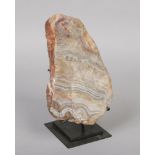 A polished banded onyx specimen on metal stand. Slab 30cm.Condition report intended as a guide