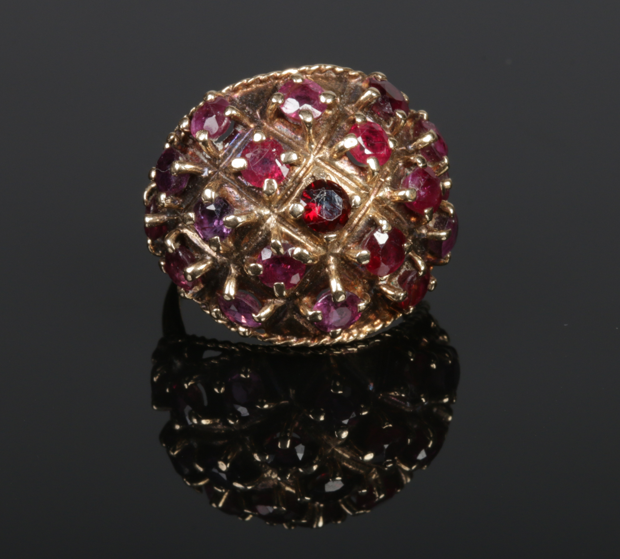 A 9 carat gold and garnet set cocktail ring. Size P.Condition report intended as a guide only.Stones