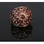 A 9 carat gold and garnet set cocktail ring. Size P.Condition report intended as a guide only.Stones