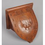 A Gothic revival carved oak wall bracket. With a crescent motif and trefoil side decorations, 22cm.