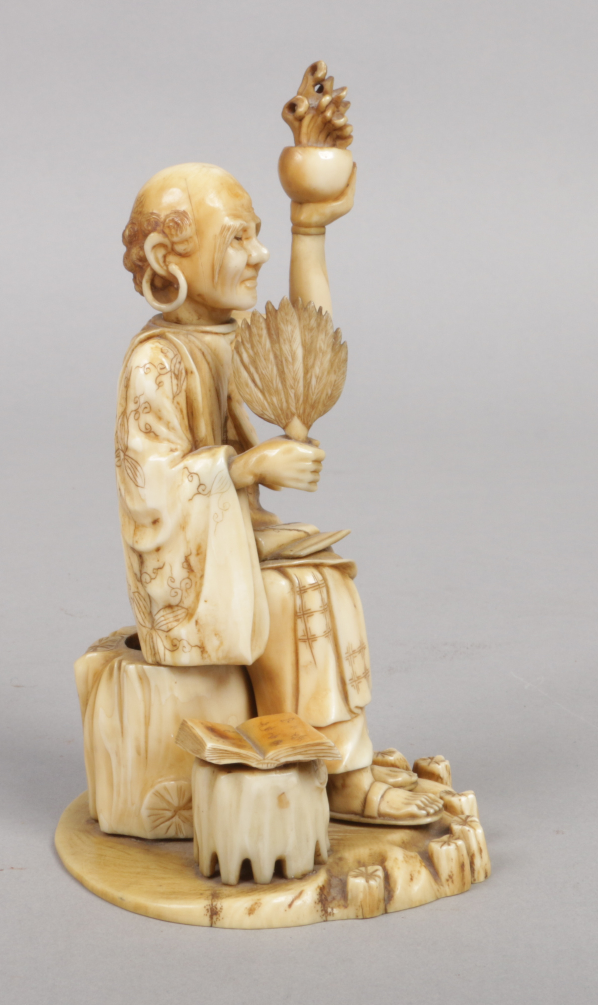 A Japanese Meiji period carved ivory okimono. Formed as a seated sage. Signed with a lacquer - Image 4 of 6