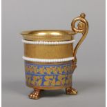 A 19th century Paris three footed cabinet cup with scrolling handle in French Empire style. With