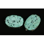 A pair of early 20th century Chinese carved and pierced turquoise pendants formed as peonies and