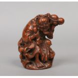 A 19th century Chinese carved bamboo figure of Shou Lao holding a branch from a peach tree and