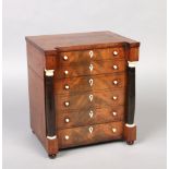 A fine Regency mahogany six bottle tantalus formed as a chest of drawers. With turned supports and