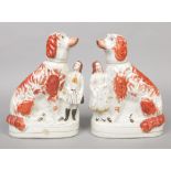 A pair of Victorian Staffordshire pottery mantel dogs coloured in enamels. Formed as king Charles