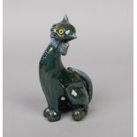 A C. H. Brannam Barum pottery novelty model of a seated cat wearing a bow tie and decorated in green