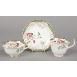 A Rockingham teacup, coffee cup and saucer with single spur handles. With green and gilt borders and