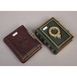 Two small Victorian photograph albums and contents of monochrome portrait photographs.