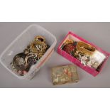 Two boxes of costume jewellery to include brooches, pendants on chains, beads etc.