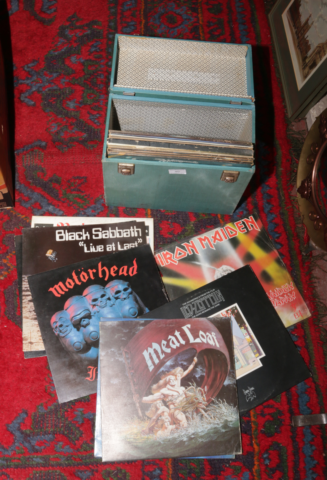 A carry case of rock L.P records to include Iron Maiden, Motor Head, Black Sabbath etc.