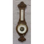 A carved oak wall barometer W. Greenwood Leeds.