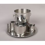 A French chrome plated Champagne bucket and a Bauhaus style three part teaset on a serving tray.
