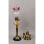 A late 19th / early 20th century brass based oil lamp with etched and ruby glass shade, along with a