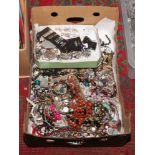 A box of costume jewellery beads,bangles, earrings etc.