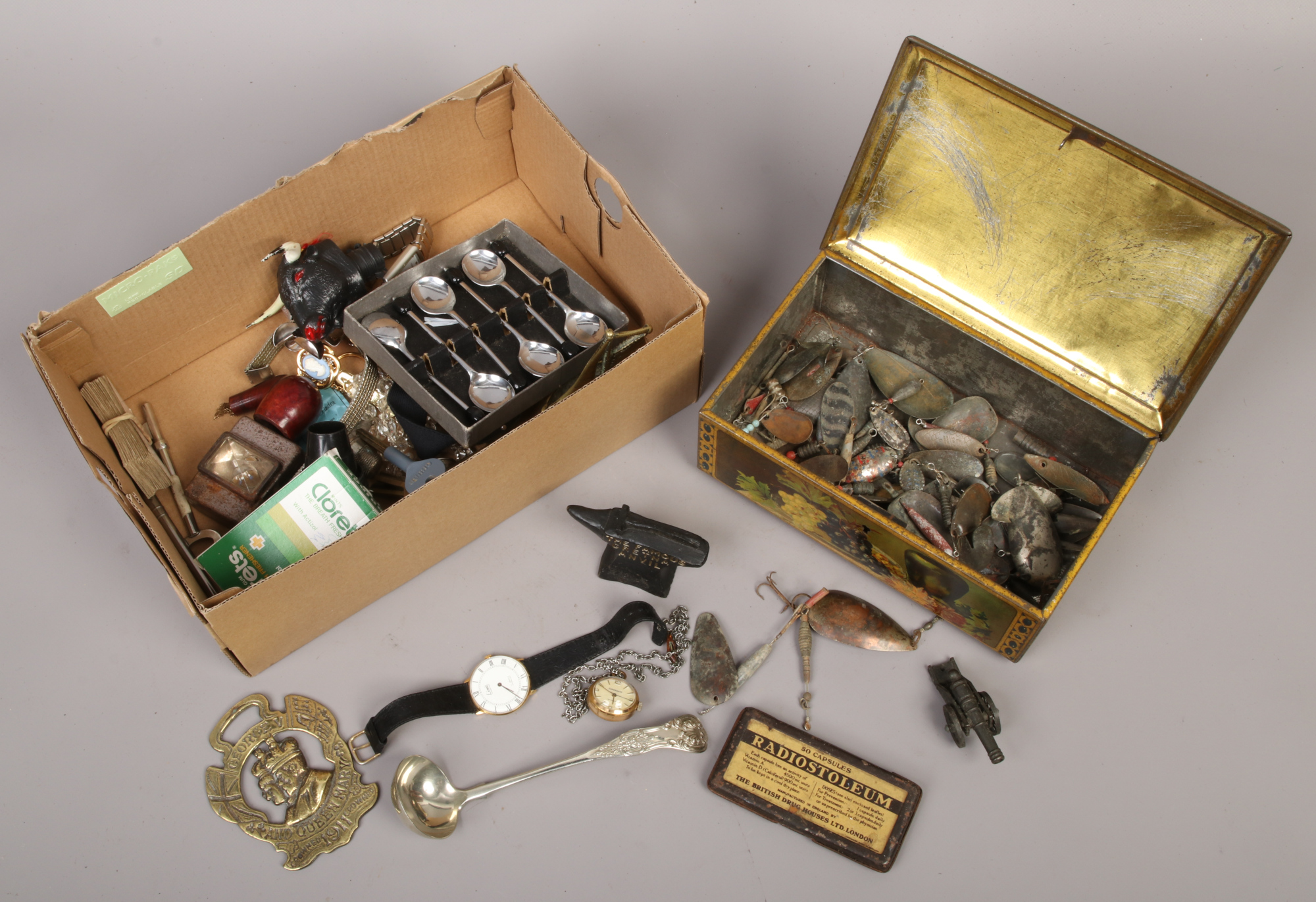 A box of collectables to include fishing spinners / weights, demitasse spoons, wristwatches etc.