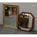 A gilt framed wall mirror and another mirror.