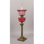 A large Victorian brass based oil lamp with ruby glass shade and font.Condition report intended as a