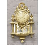 An ornate gilt 8 day wall clock with sunburst decoration and mirrored back panel.