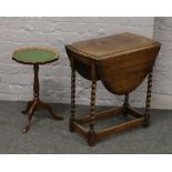 A carved oak barleytwist drop leaf occasional table, along with a leather top tripod wine table.