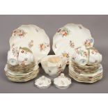 A collection of Coalport bone china teawares of scolloped design decorated with flowers, 36 pieces.