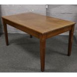 A mid 20th century mahogany table raised on square tapering supports.