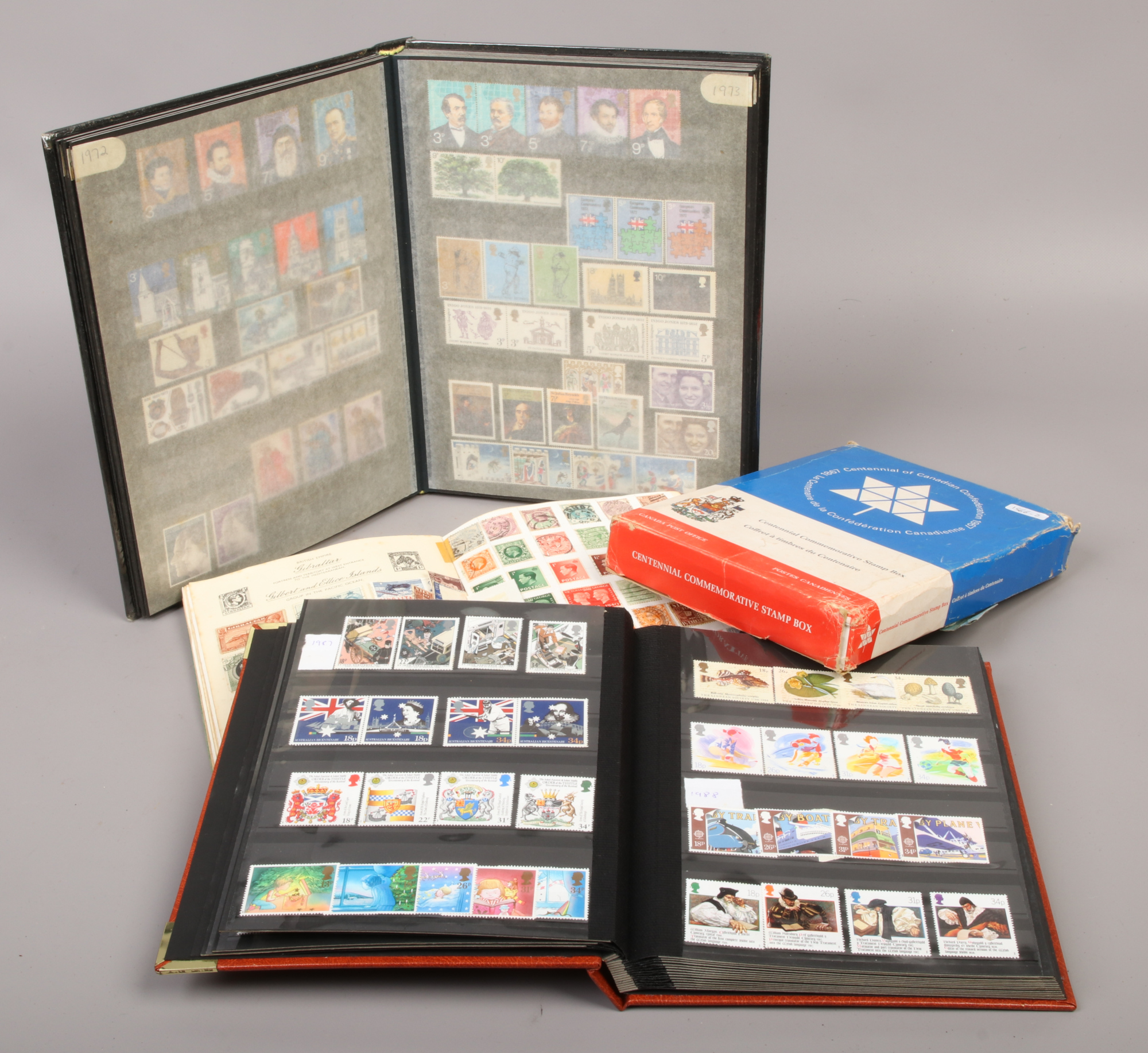 A Royal Mail stamp album of world stamps, along with two albums of British Mint stamps and a