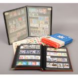 A Royal Mail stamp album of world stamps, along with two albums of British Mint stamps and a