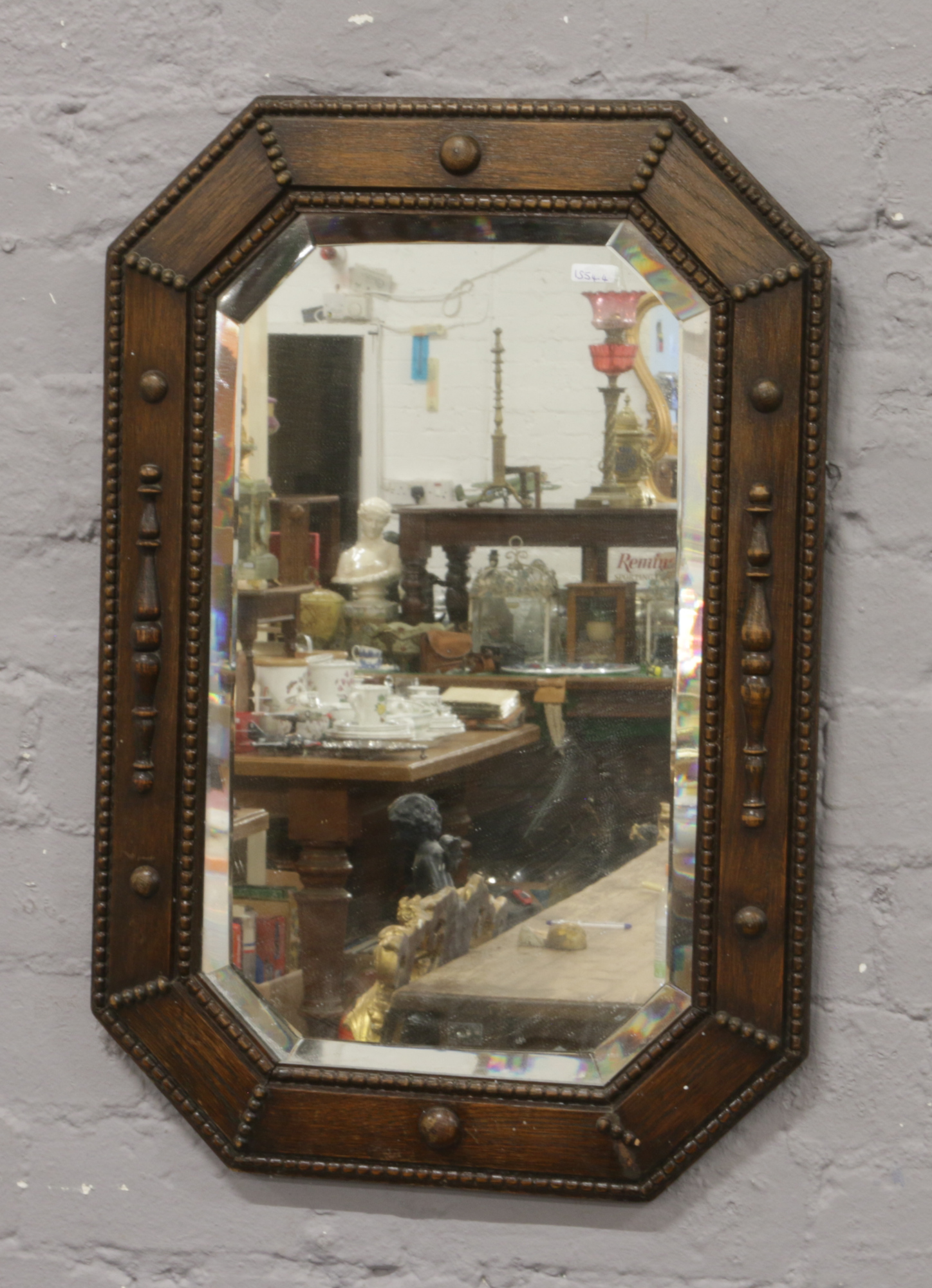 A carved oak bevel wall mirror.