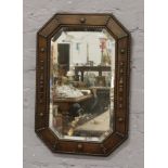 A carved oak bevel wall mirror.